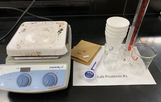 2019 USNCO Part III Problem 1 setup: hot plate/stirrer, thermometer, Erlenmeyer flasks, timer for H₂O₂ decomposition calorimetry