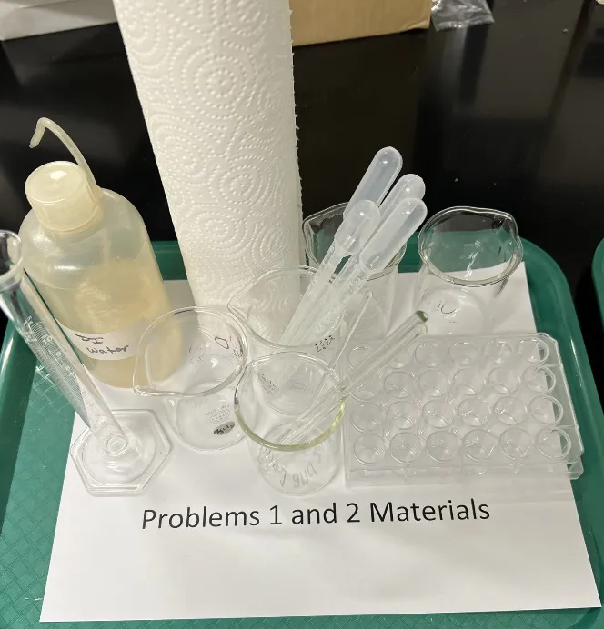 2023 USNCO Part III shared materials: DI water, beakers, Beral pipets, well plate, paper towels